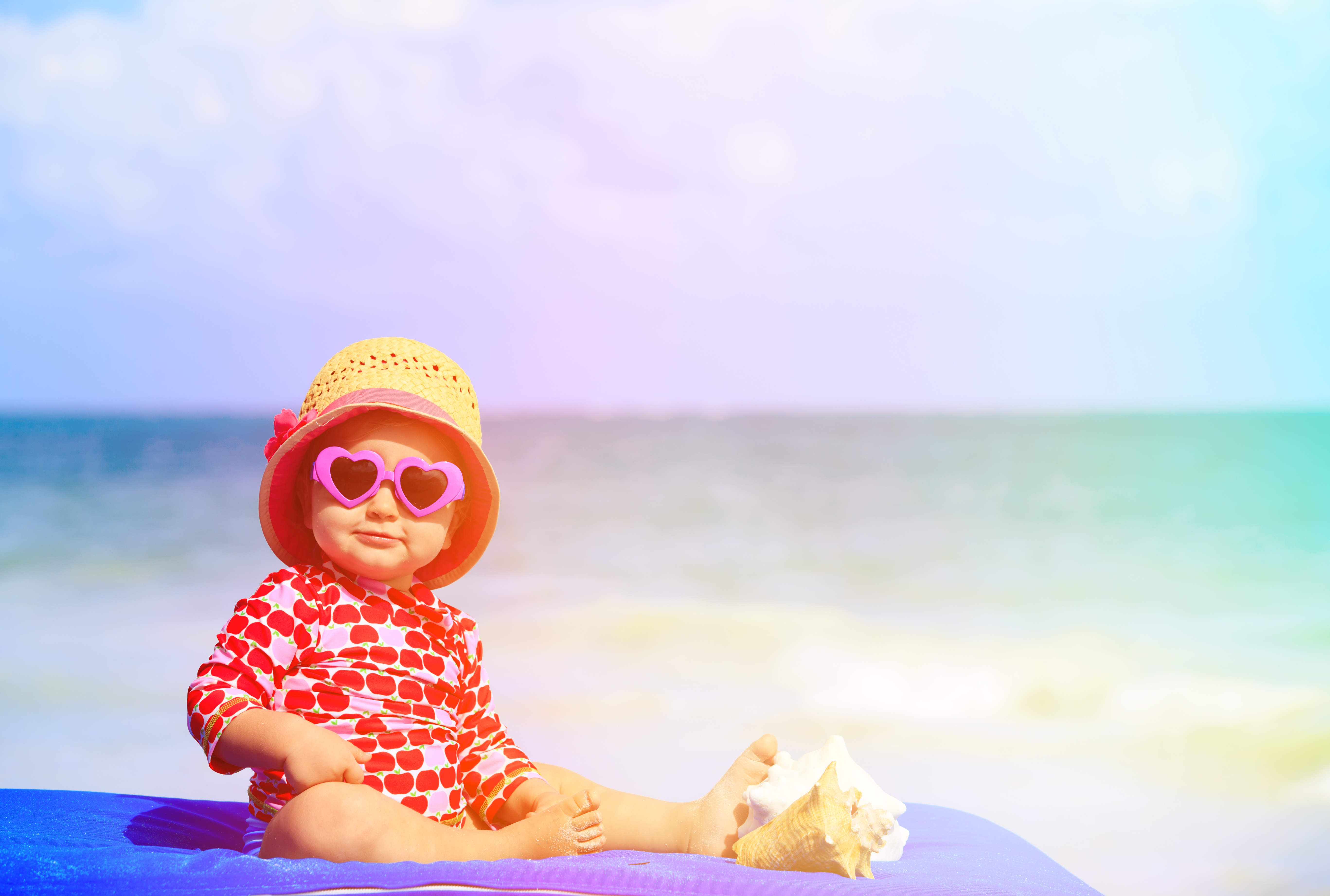cute little girl with seashells on the beach